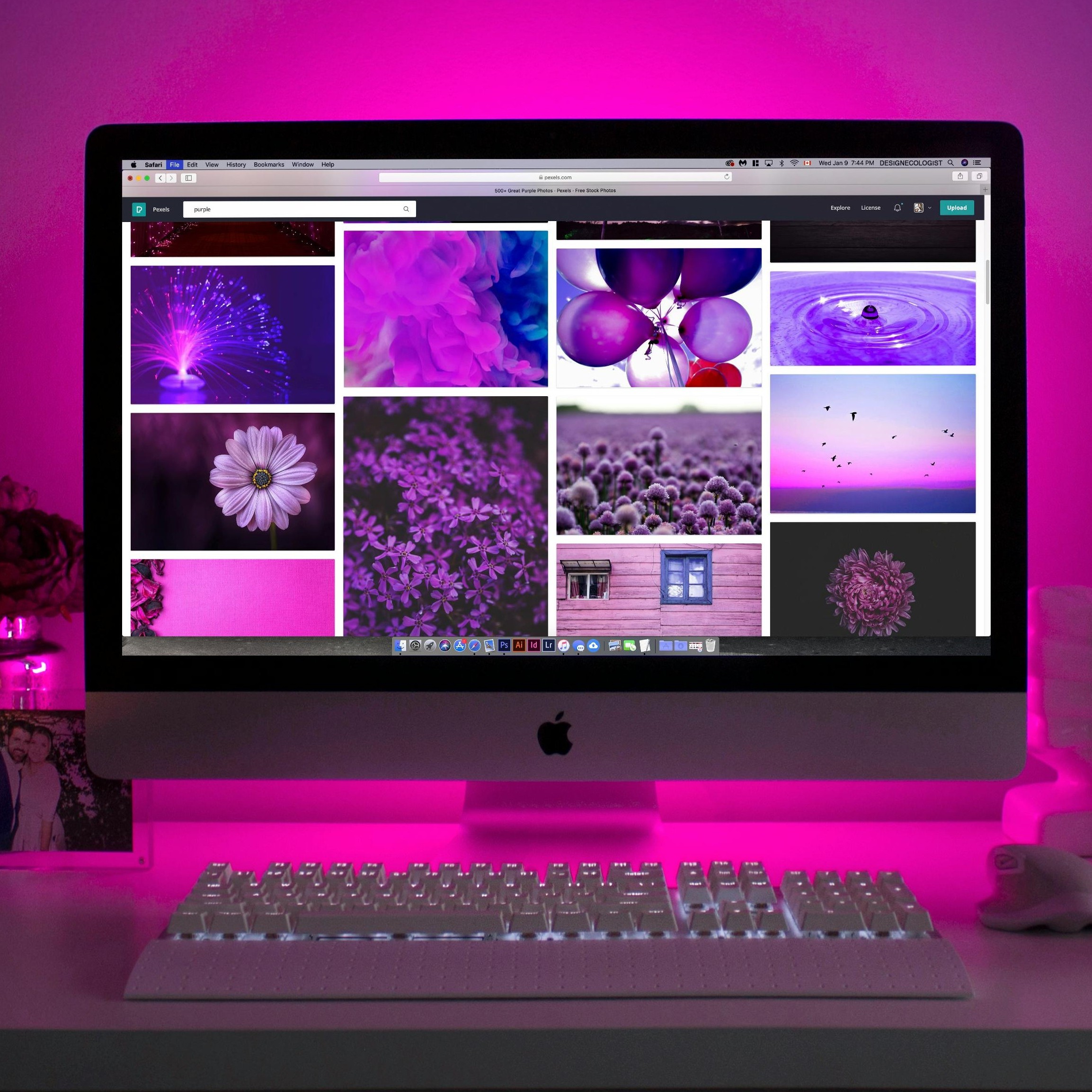 image of computer desk with purple lighting and various purple images in the background