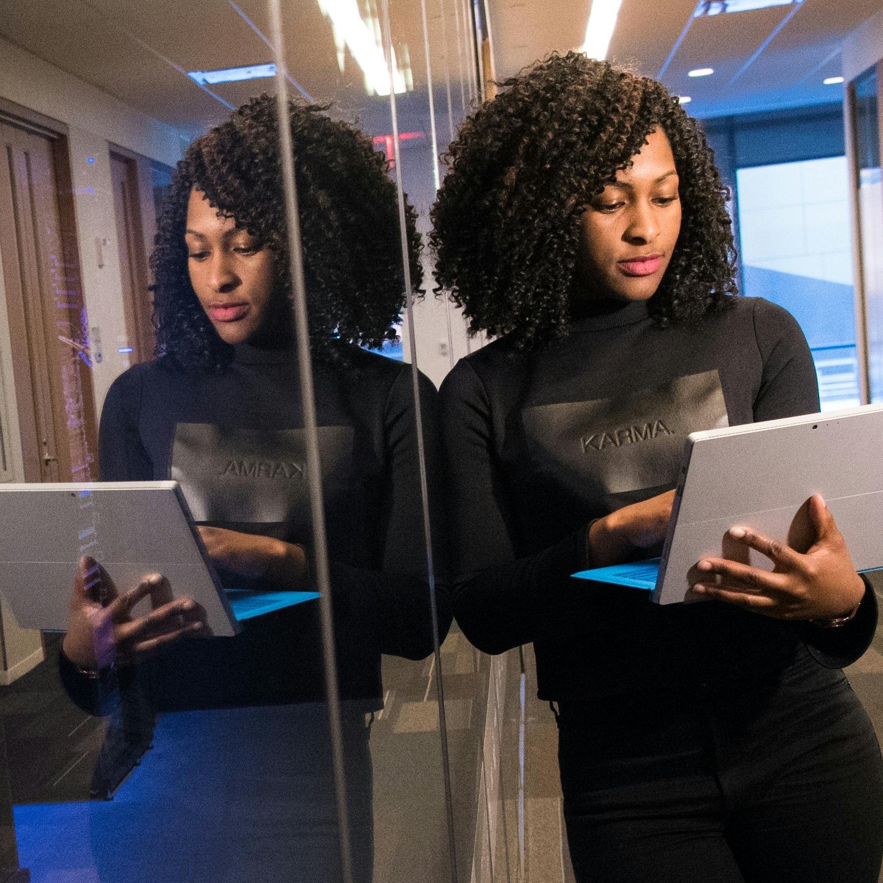 image of a person leaning on a desk next to a briefcase surrounded by money.
