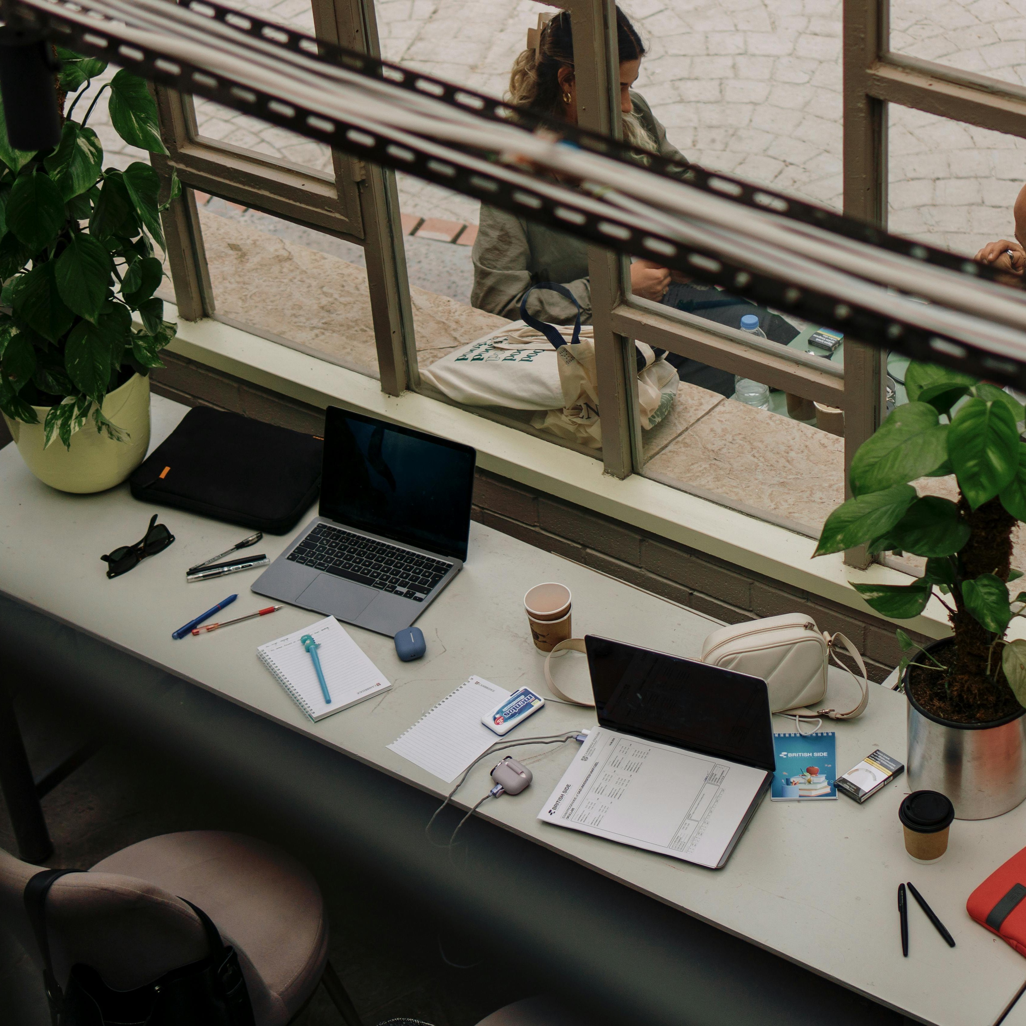 image of a person leaning on a desk next to a briefcase surrounded by money.